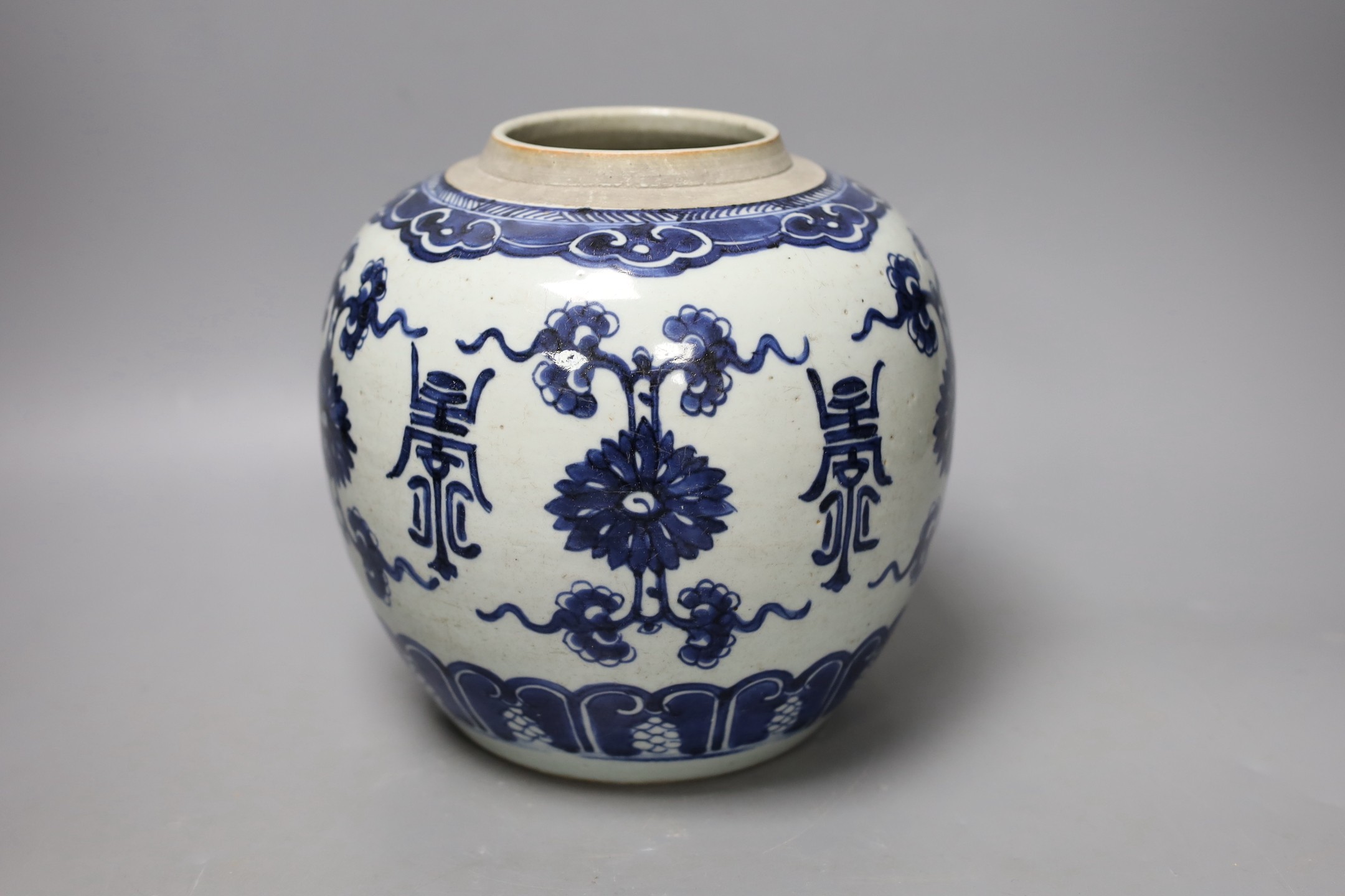 An 18th century Chinese blue and white jar, painted with ‘shou’, flowers and tendrils, 22cm high